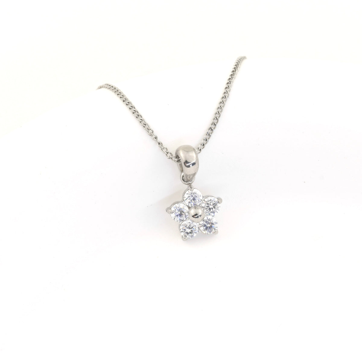 Silver necklace with a flower-shaped pendant on a white background