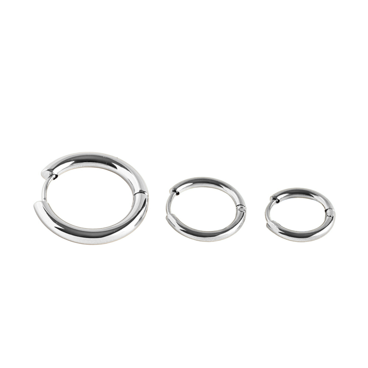 Close-up view of subtle silver hoop earrings with clicker closure in small, medium and large sizes on a white background