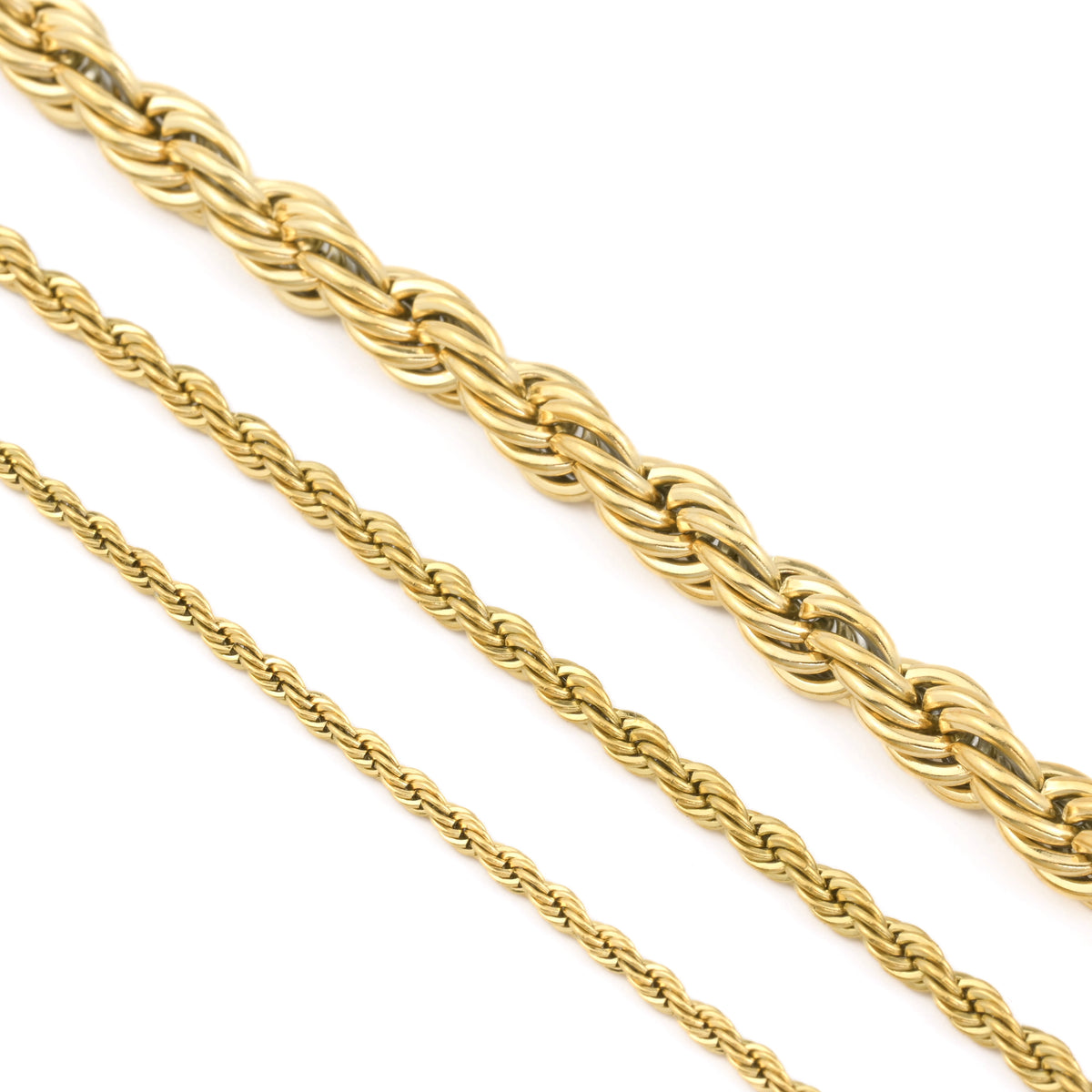Gold rope chains of different sizes on a white background