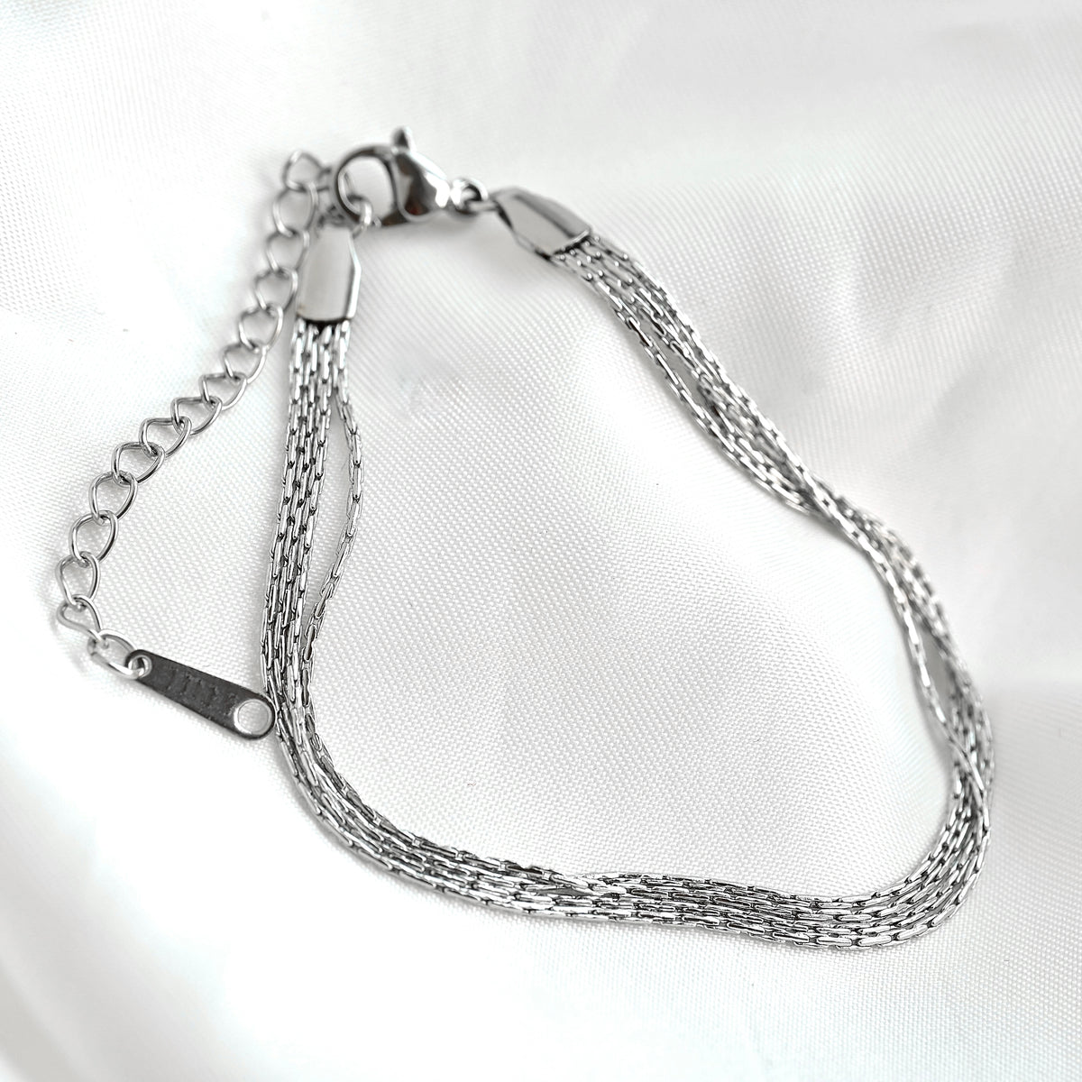 Silver chain bracelet on a white background