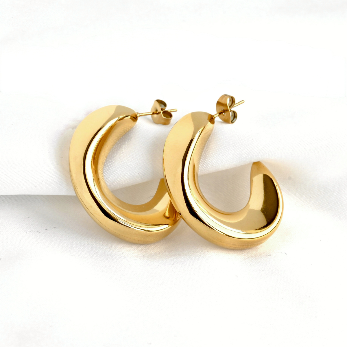 Gold hoop earrings on a white background