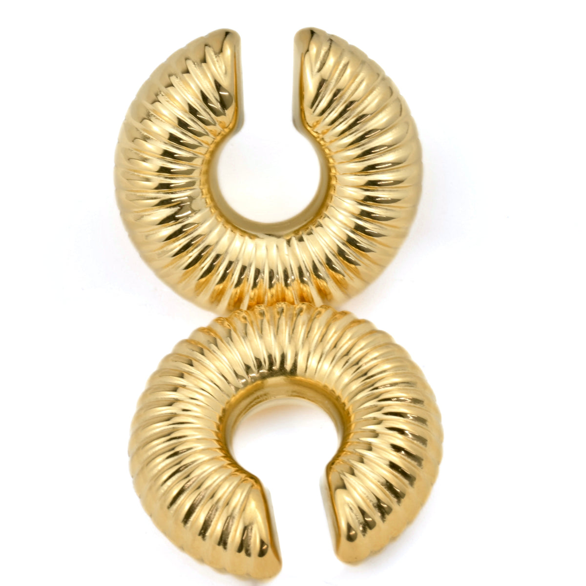 Pair of ribbed hoop cuff earrings on a white background