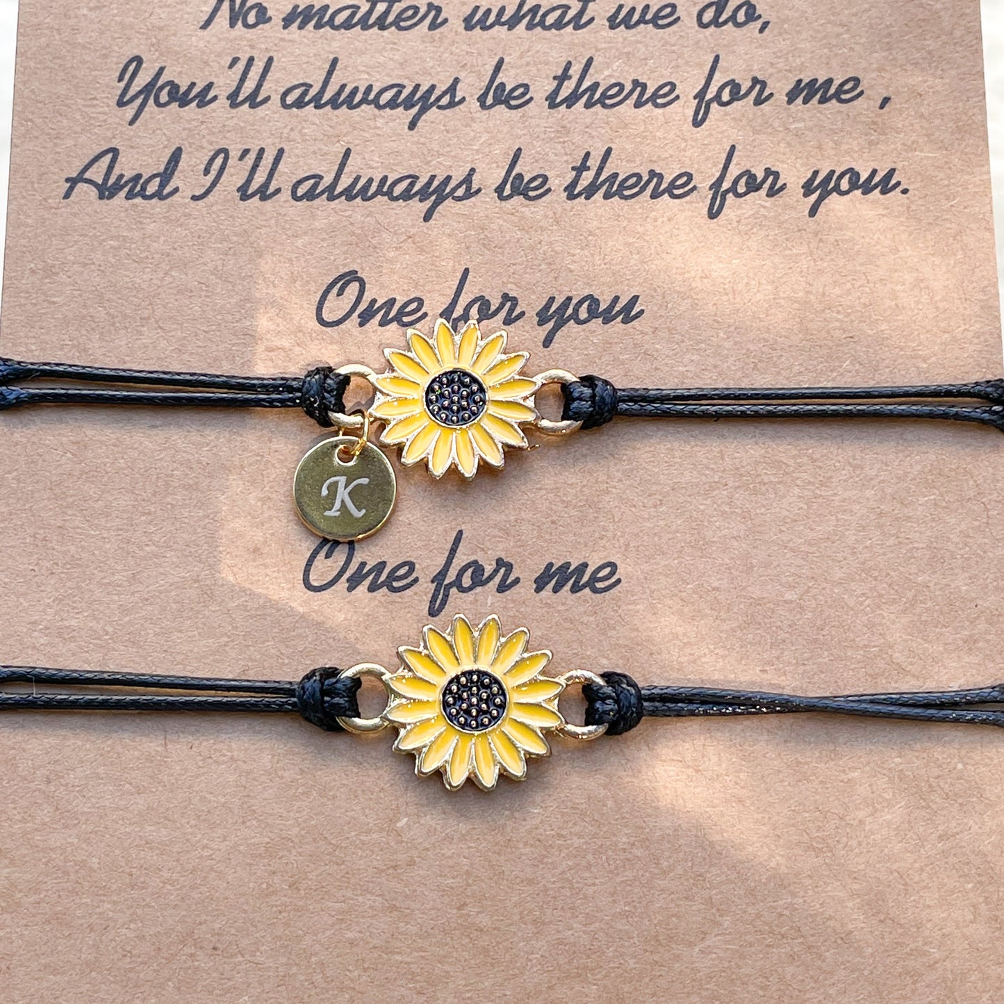 Front view of two yellow flower bracelets on a card with a quote