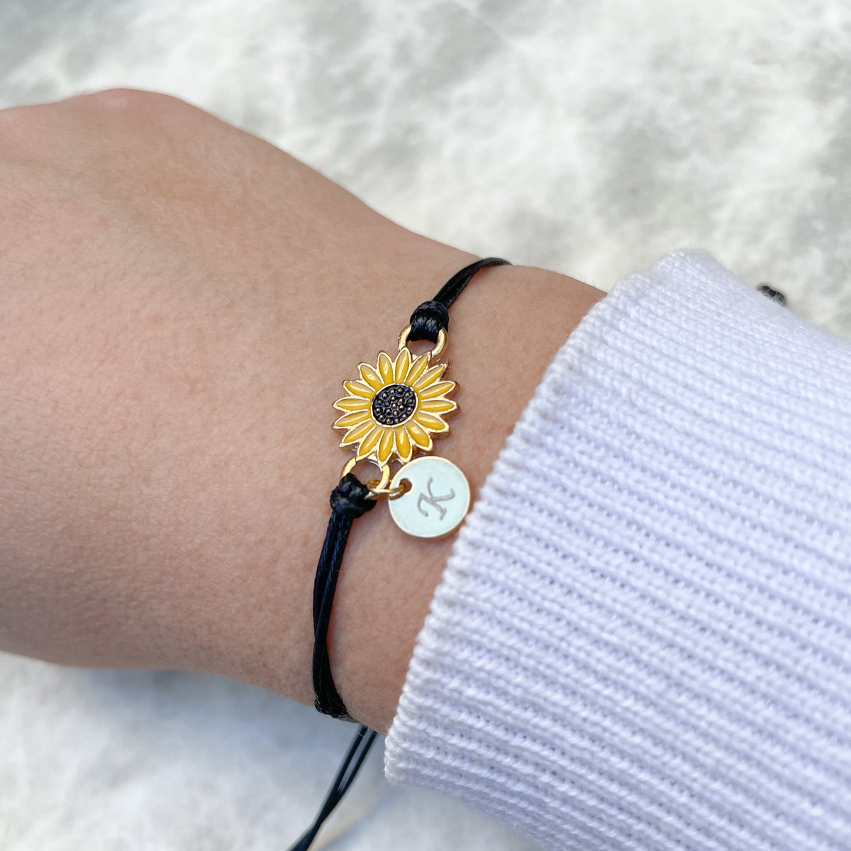 Sunflower bracelet on a wrist with a white background