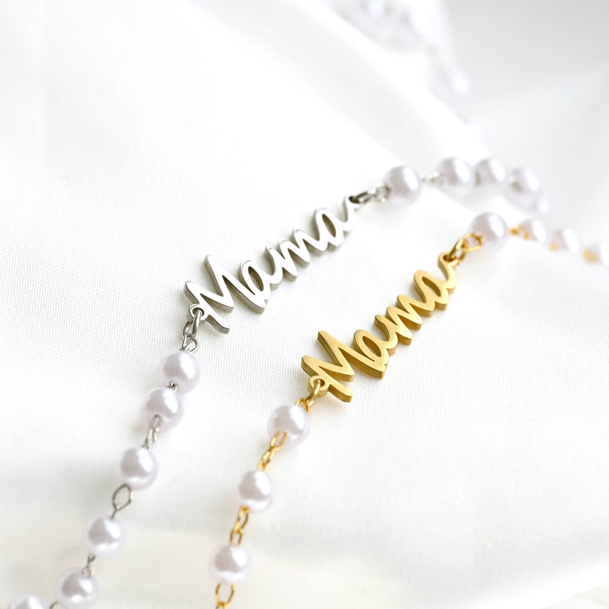 Two necklaces with 'Mama' pendants on a white background
