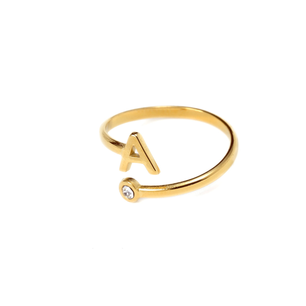 Gold ring with letter 'A' and small gemstone on a white background