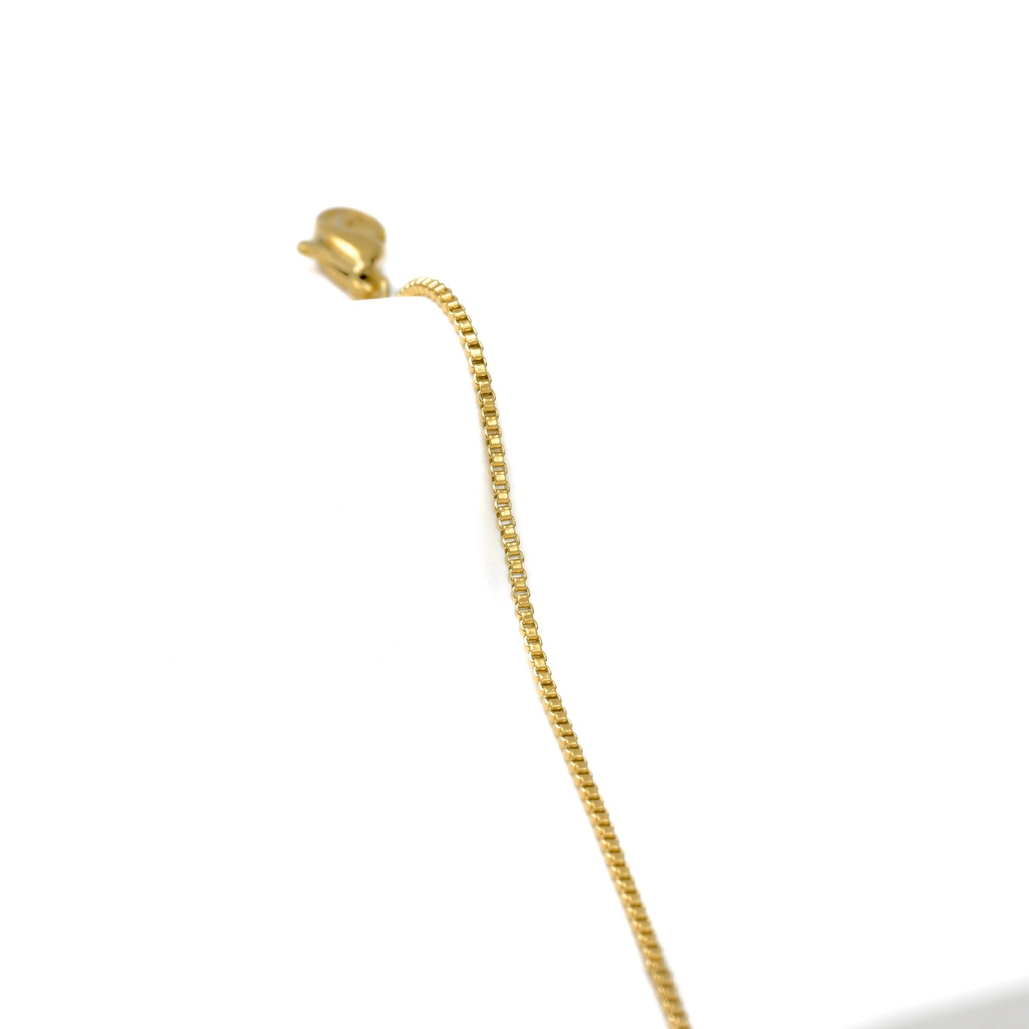 Gold box chain with a lobster clasp on a white background
