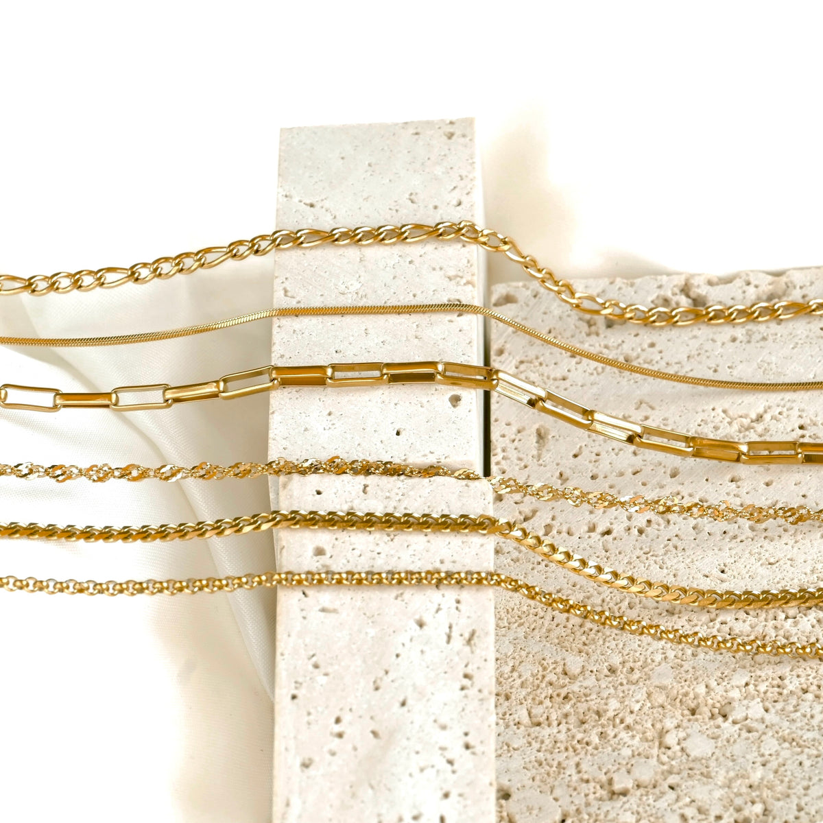 horizontal view of chains on a textured stone surface