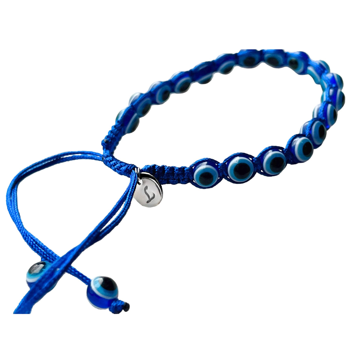 Blue bracelet with eye-shaped beads, blue thread, a square sliding knot and a silver initial charm 'L' on the knot on a white background