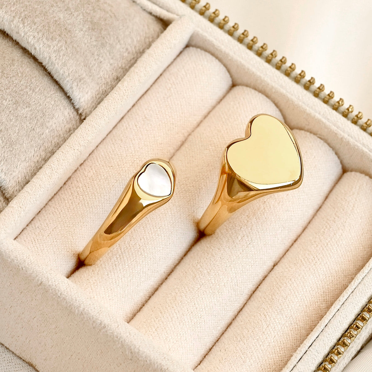 Two bold heart rings in a jewelry box