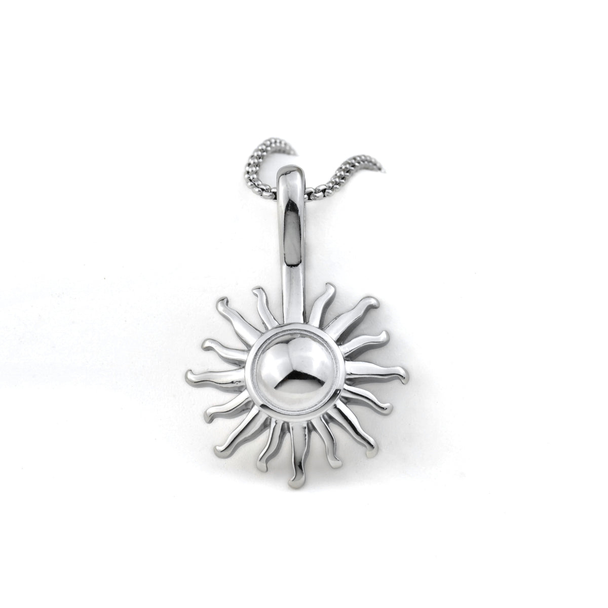 Close up front view of silver sun pendant on a white background