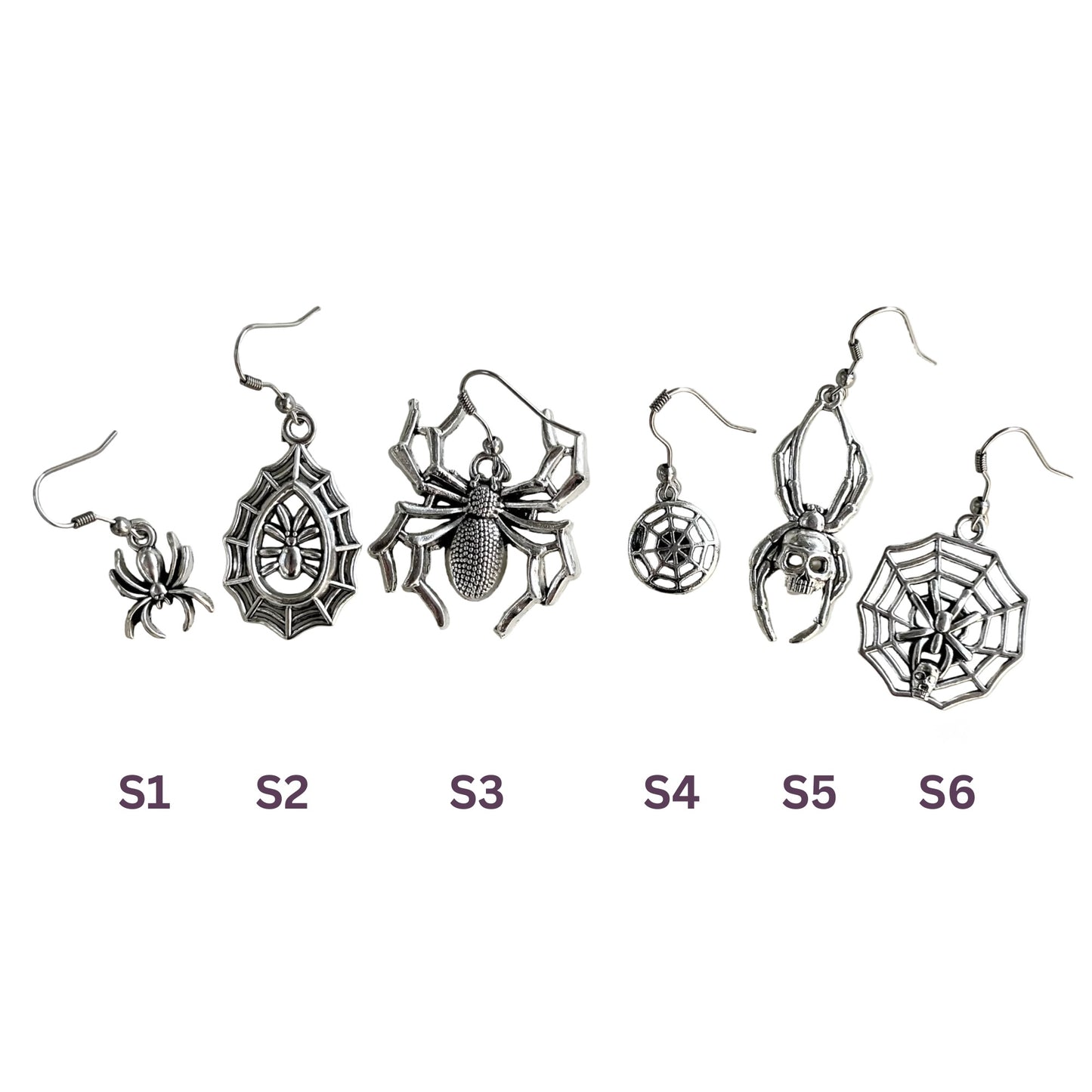 Set of six pairs of spider-themed earrings on a white background