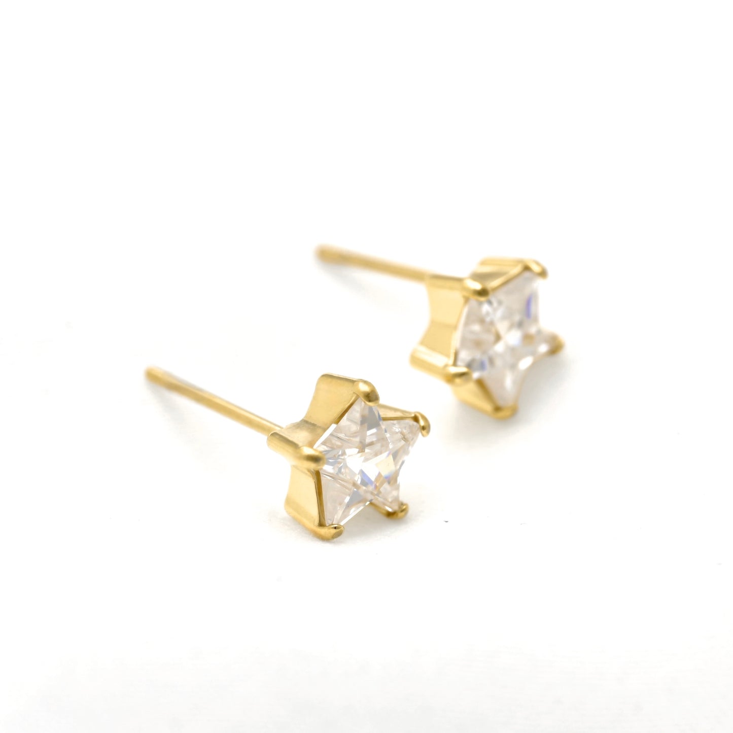 A pair of gold stud earrings with clear, faceted star-shaped crystals, displayed on a clean white background.