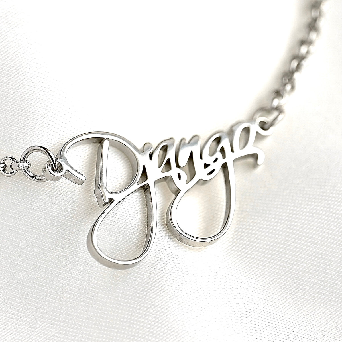 Silver bracelet with 'Django' in a fancy cursive font on a white background
