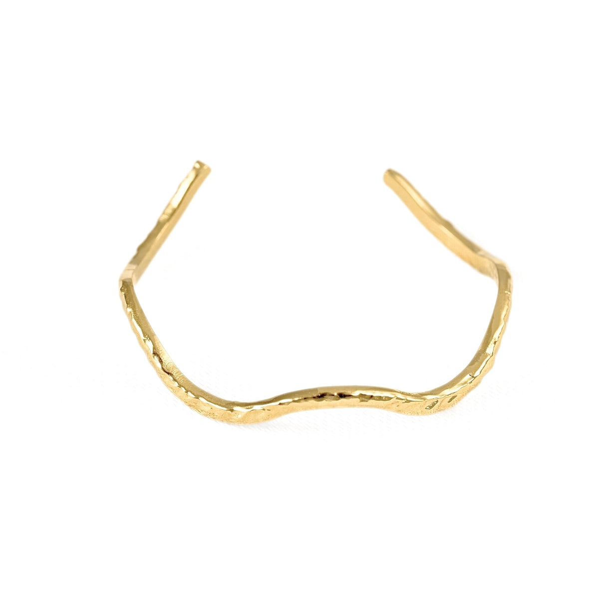A gold open cuff ring with a textured, organic wavy design, photographed on a solid white background.