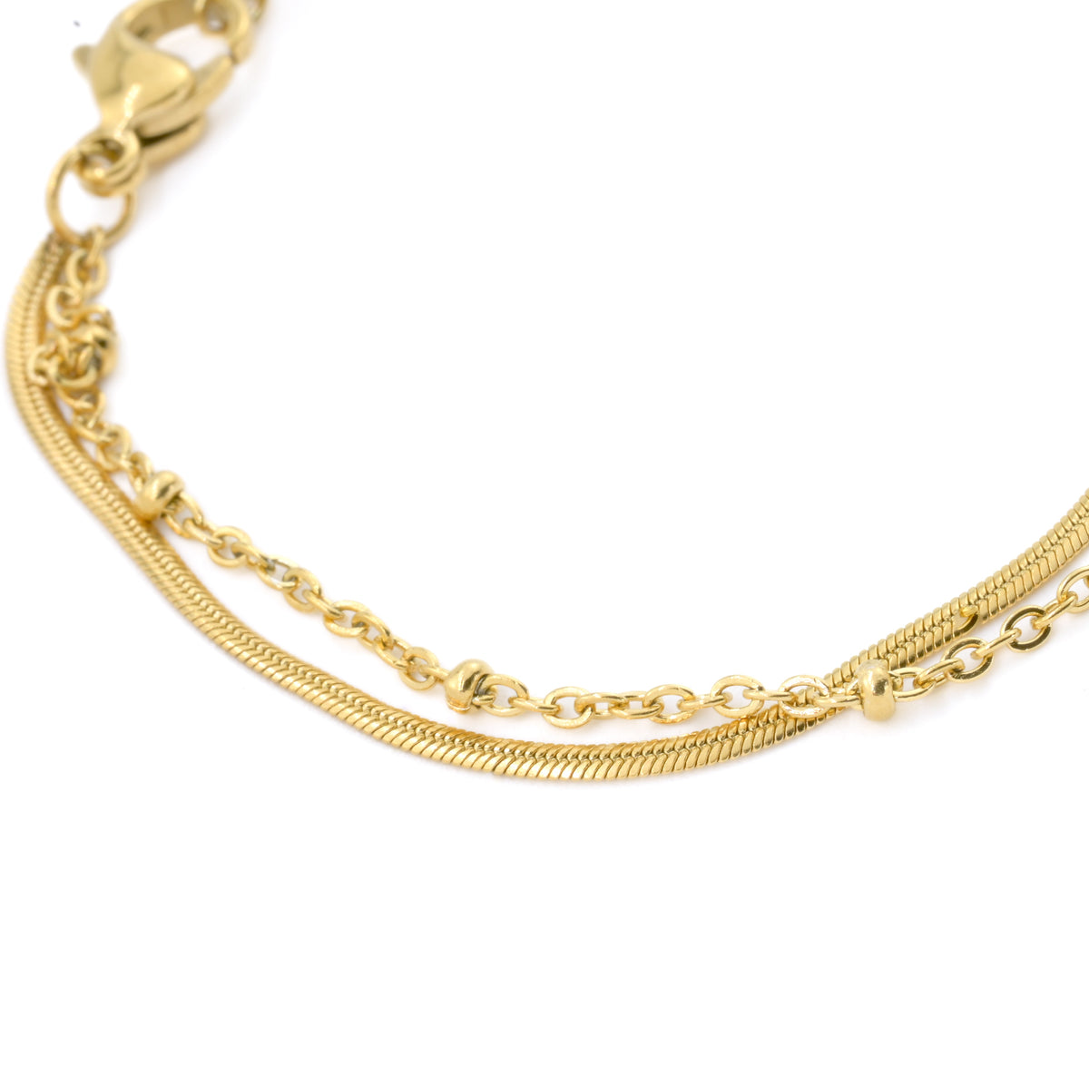Close up view of the two chains of the gold anklet: thin flat snake, and gold beaded satellite on a white background