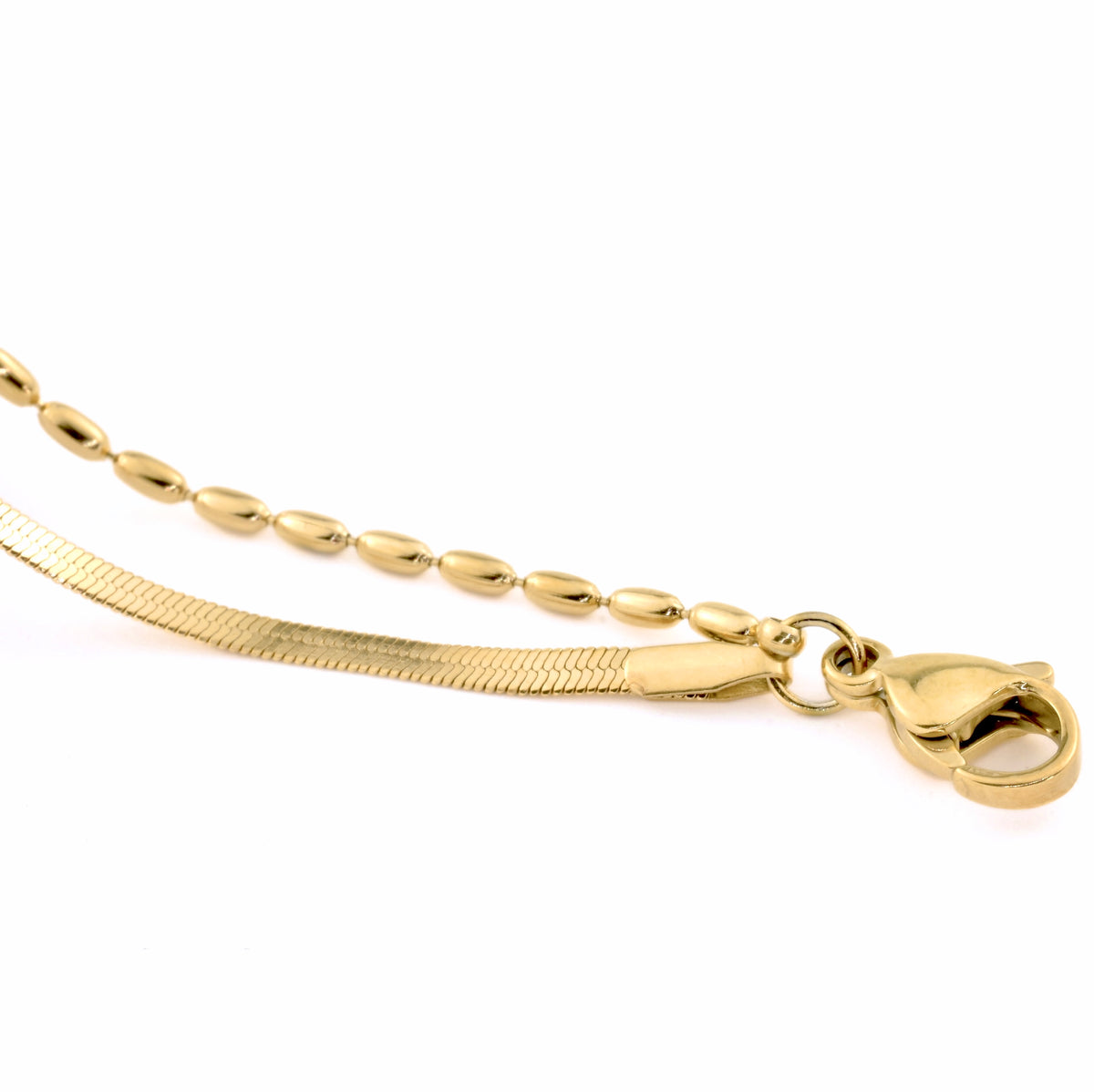 Lobster claw clasp of the layered gold anklet that links a herringbone chain and oval beaded chain on a white background