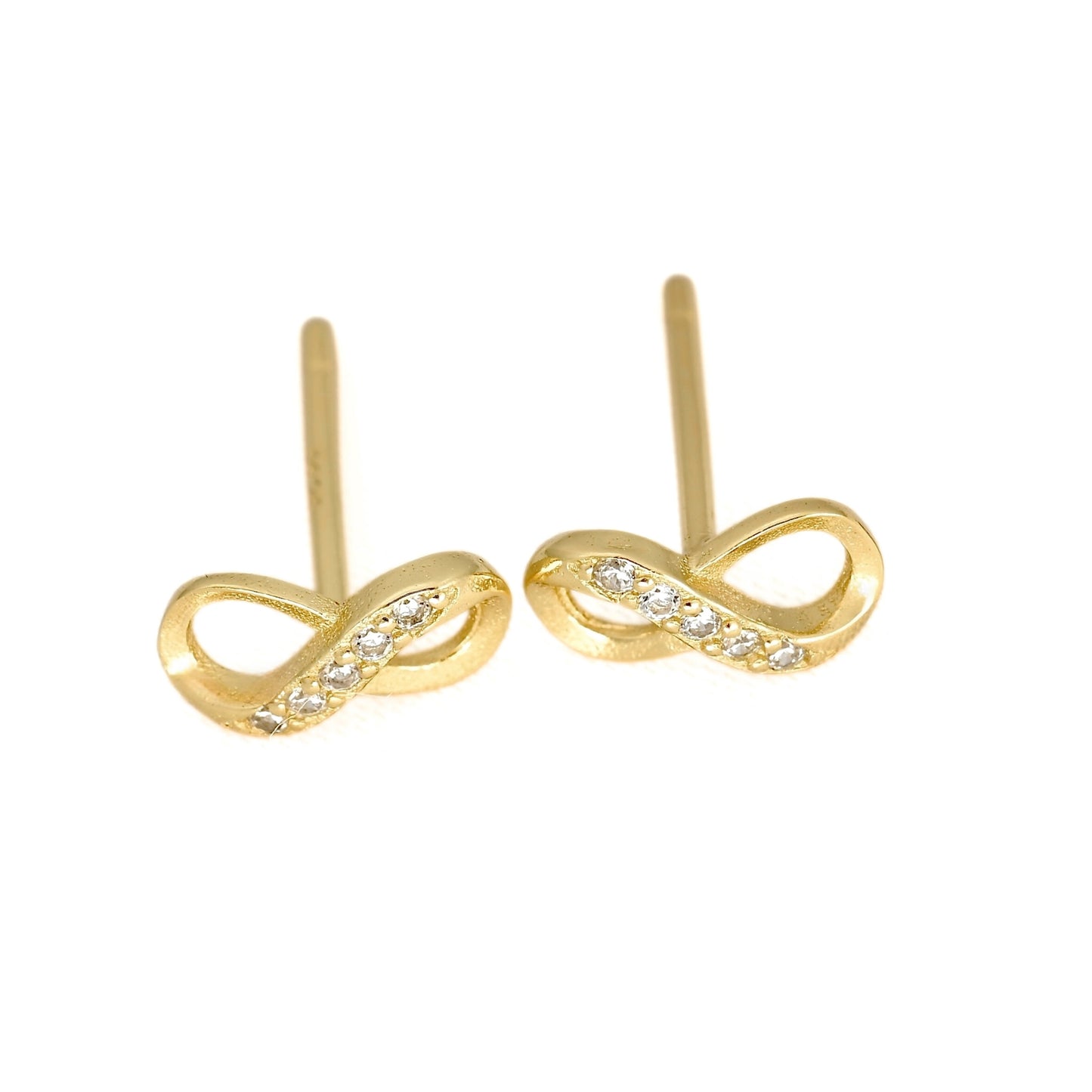 A pair of gold infinity loop stud earrings with small clear stones set along the front curve, shown on a plain white background.