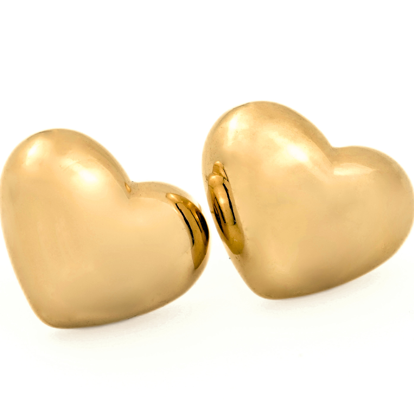 Gold puffed heart studs on a white background