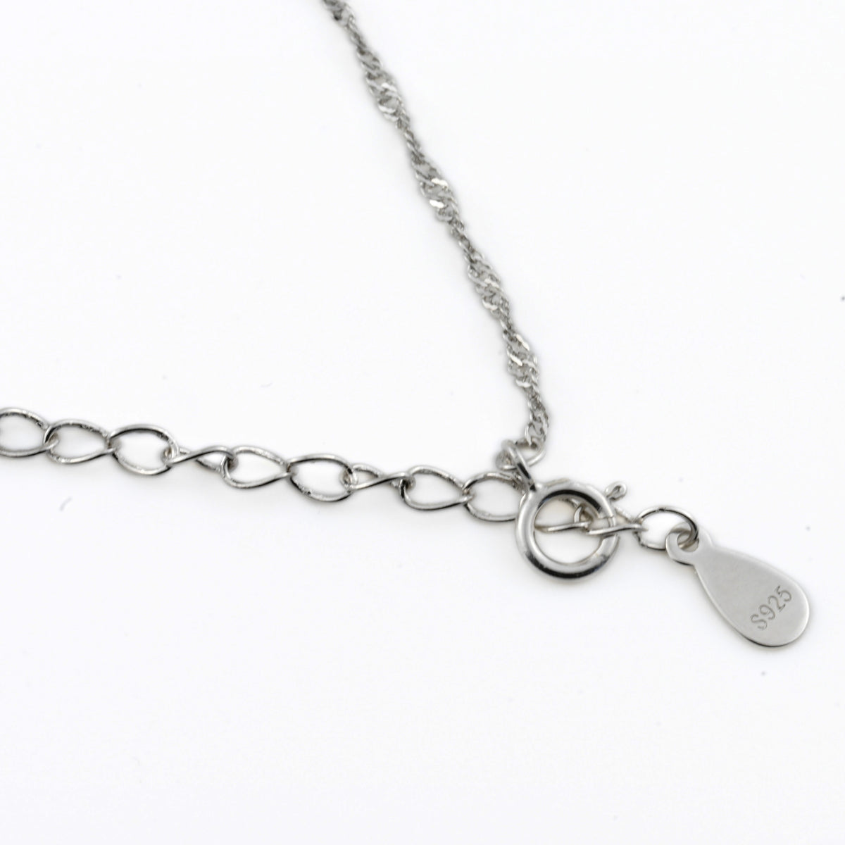 Silver singapore chain with a spring ring, extender and S925 stamped tag on a white background