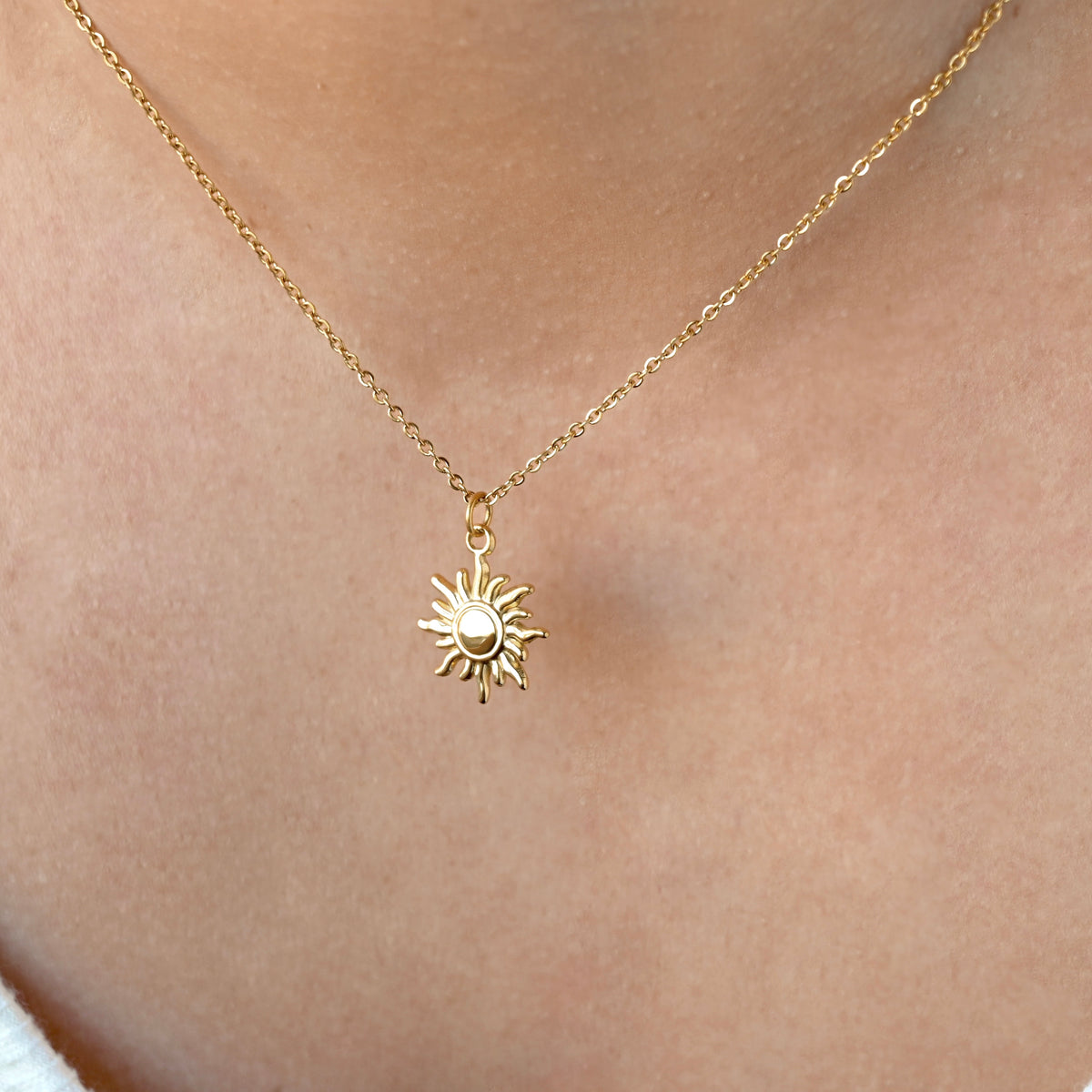Gold dun necklace with on a person's neck