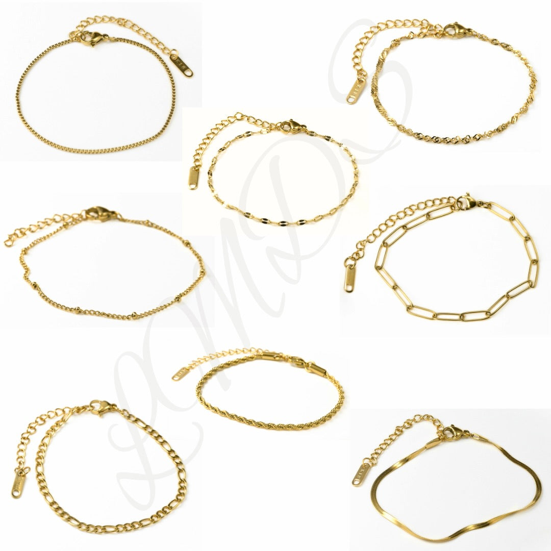 A grid of eight individual photos showcasing various gold-toned chain bracelets against a white background. The collection features different:
Top row: A fine curb chain, a flat mariner/anchor link chain, and a twisted Singapore chain.
Middle row: A satellite chain and a rectangular paperclip link chain.
Bottom row: A Figaro chain, a rope chain, and a sleek flat snake chain.
Each bracelet includes a lobster claw clasp and extender.