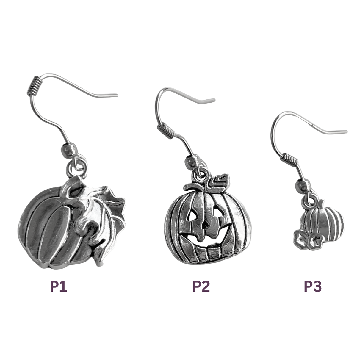 Three silver pumpkin earrings of different sizes on a white background