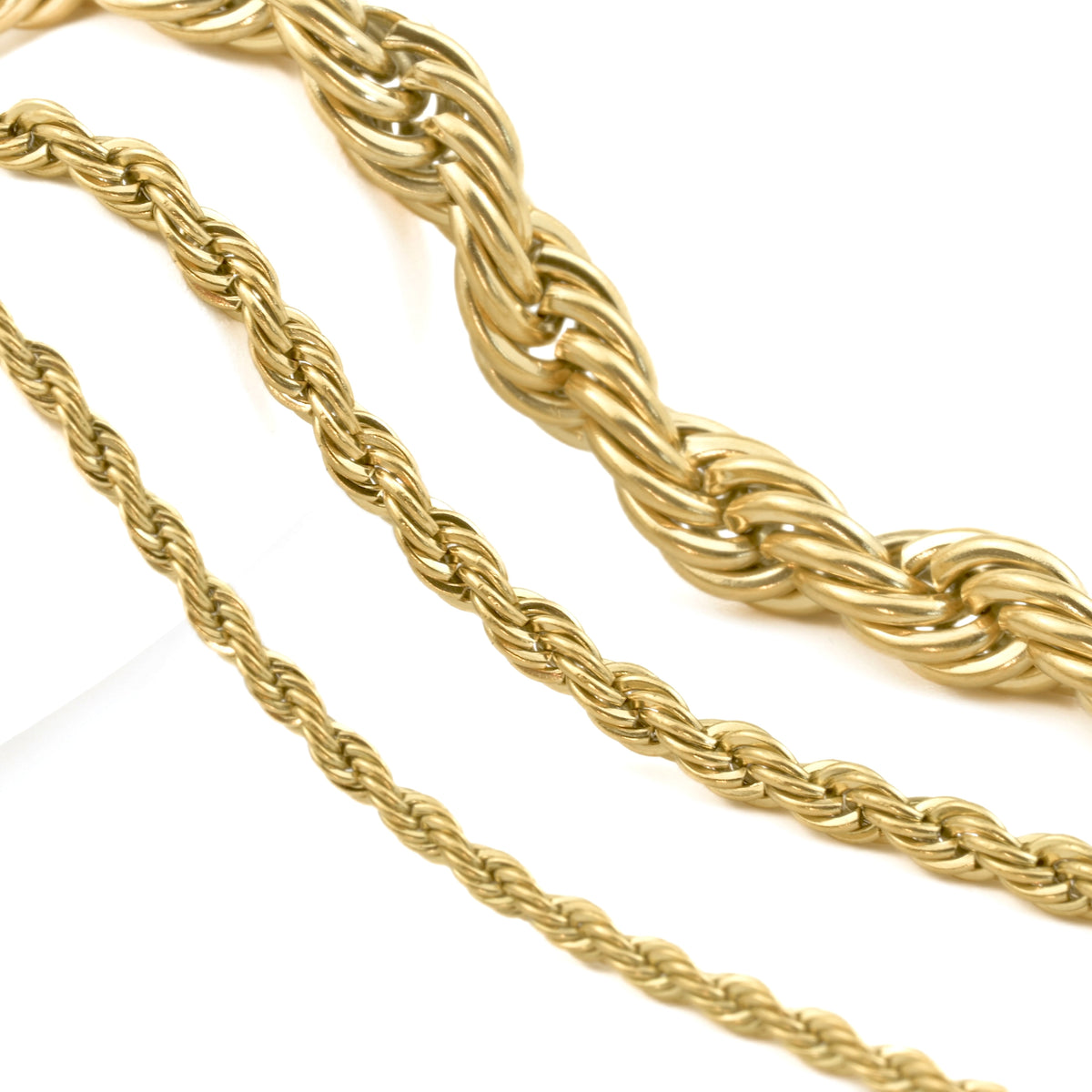 2mm, 3mm and 6mm gold rope chains on a white background
