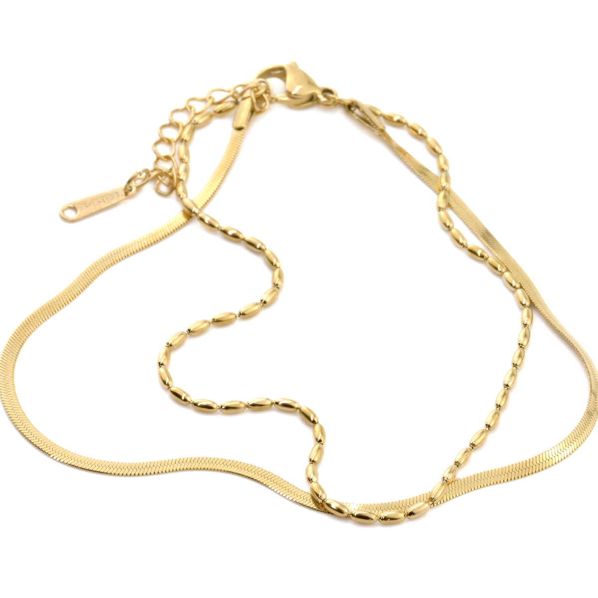 Gold chain bracelet on a white background from a different angle