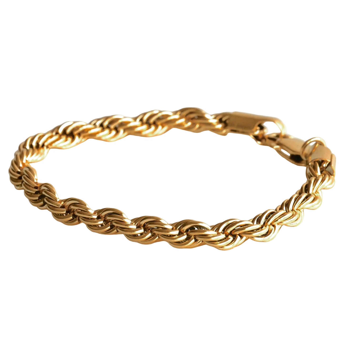 Gold braided bracelet on a white background