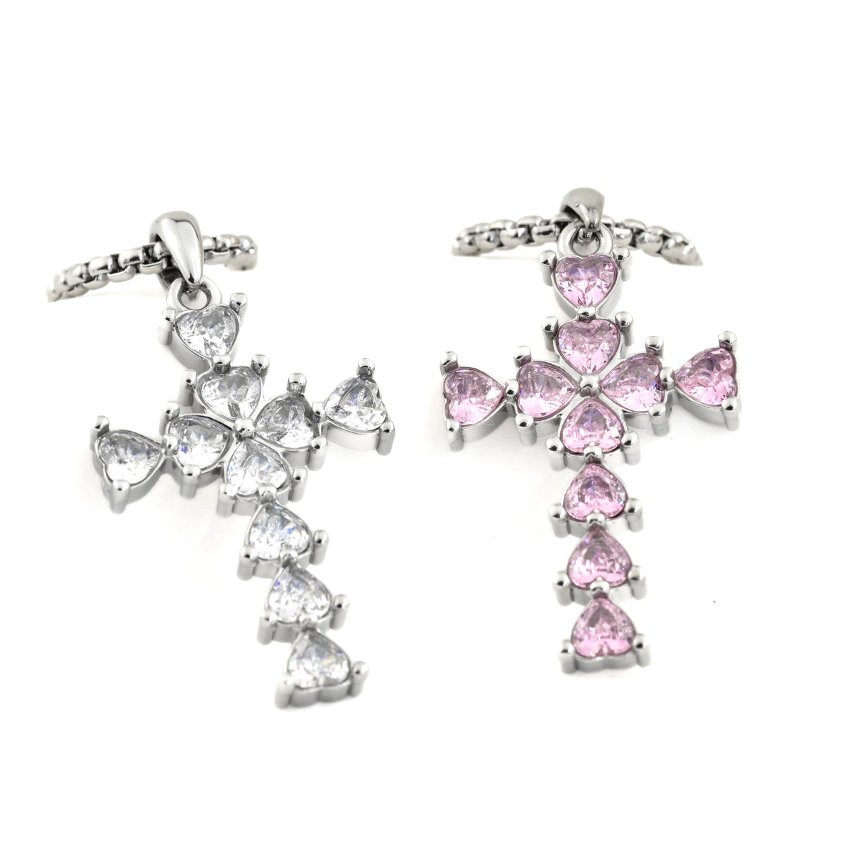 Oversized cross necklaces with pink and clear gemstones on a white background