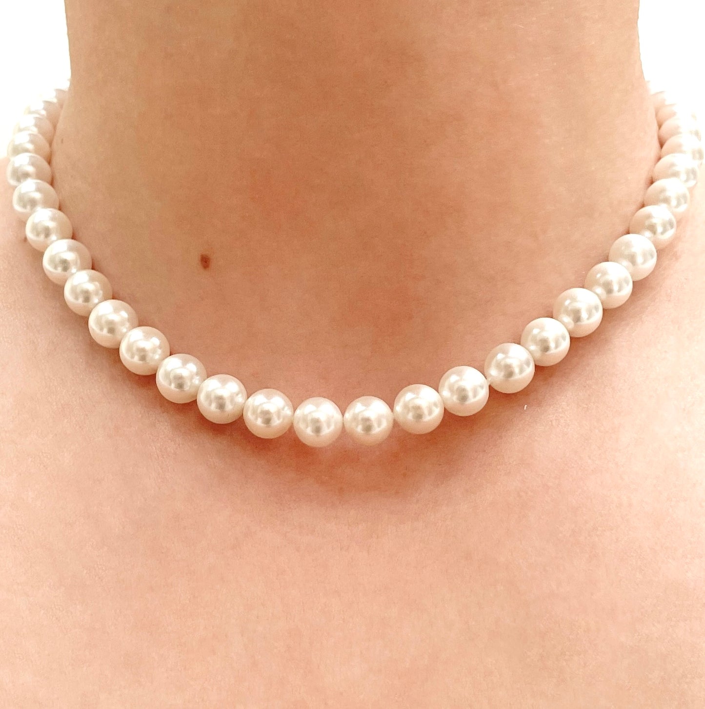 8mm Pearl necklace in 16 inches being worn on a person's neck