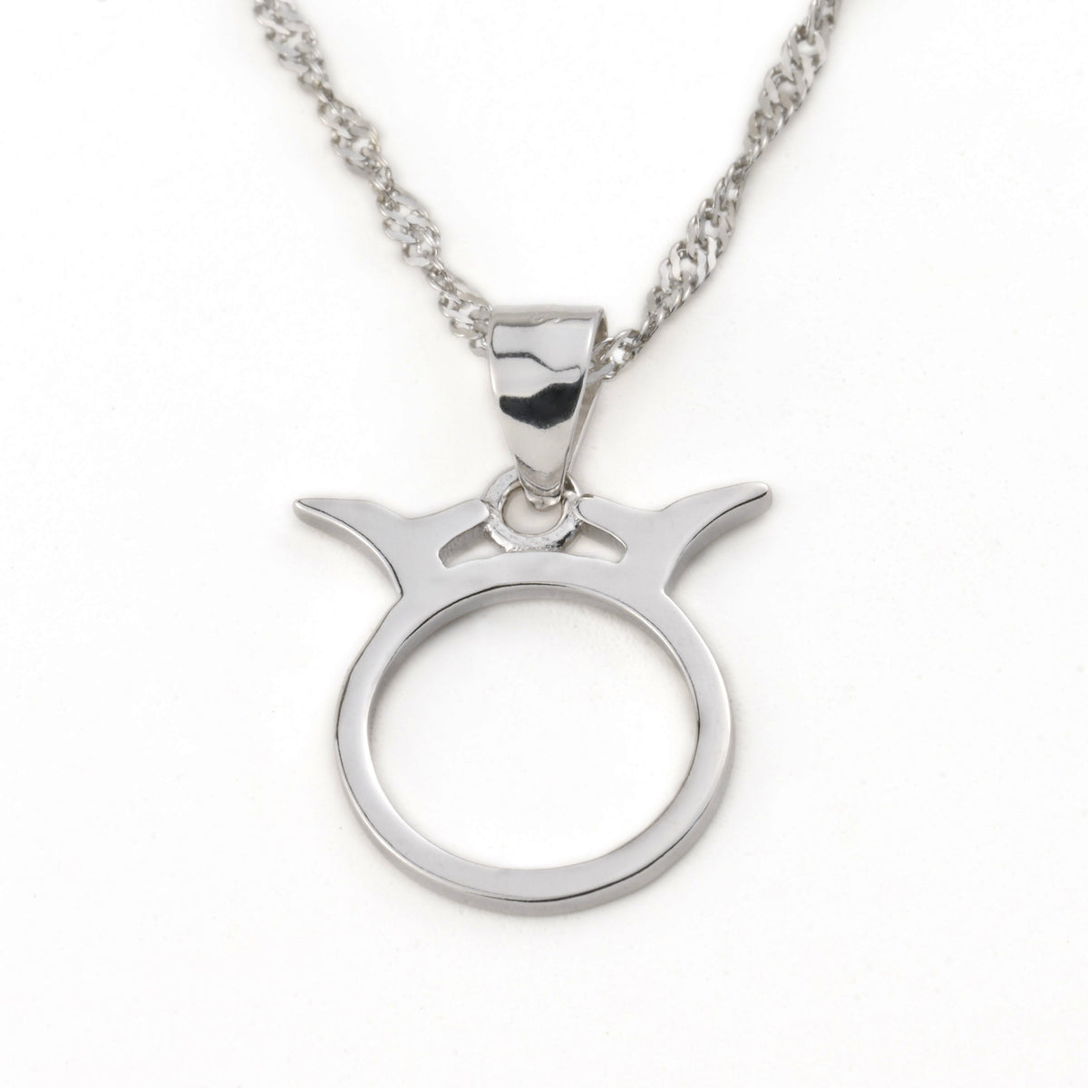 Silver Taurus pendant necklace on a white background