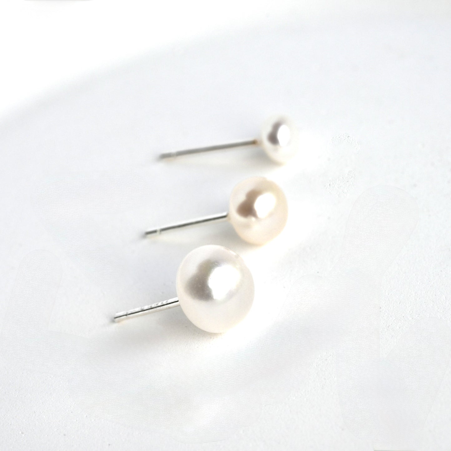 side view of pearl earrings with S925 stamp on the post.