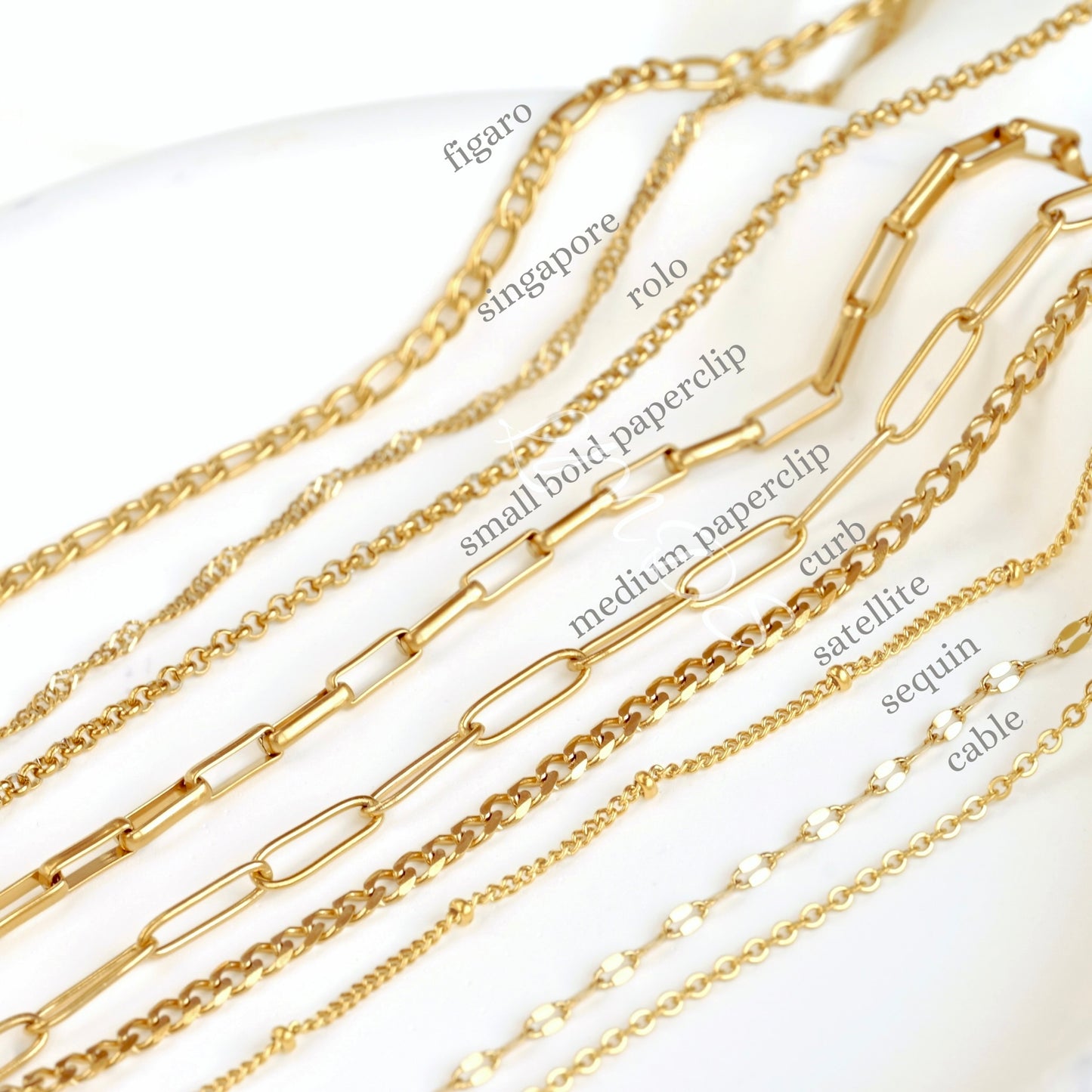 Gold chains with various designs on a white background