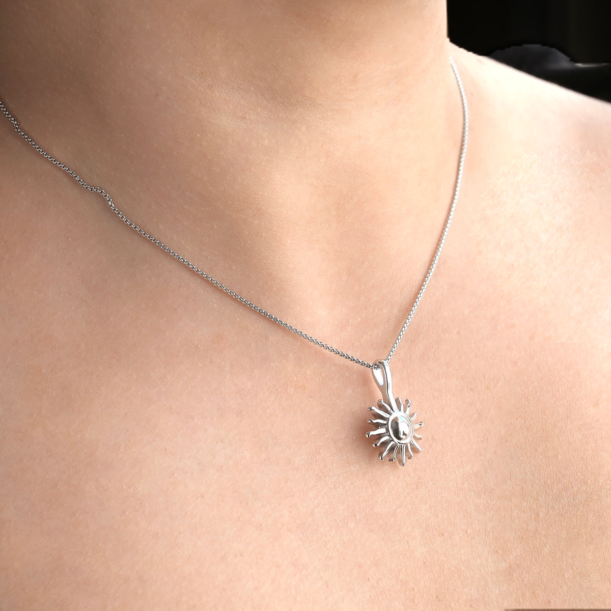 angled view of the Silver necklace on a person's neck