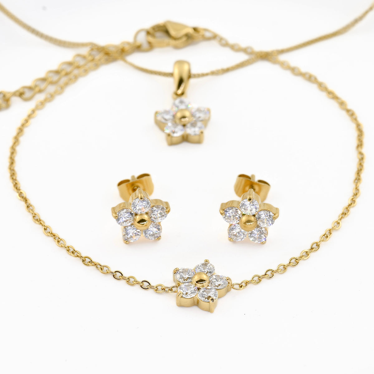 front view of the. Gold jewelry set with floral designs on a white background