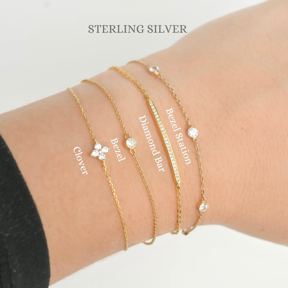Gold bracelets with various designs on a wrist, labeled 'Sterling Silver'.