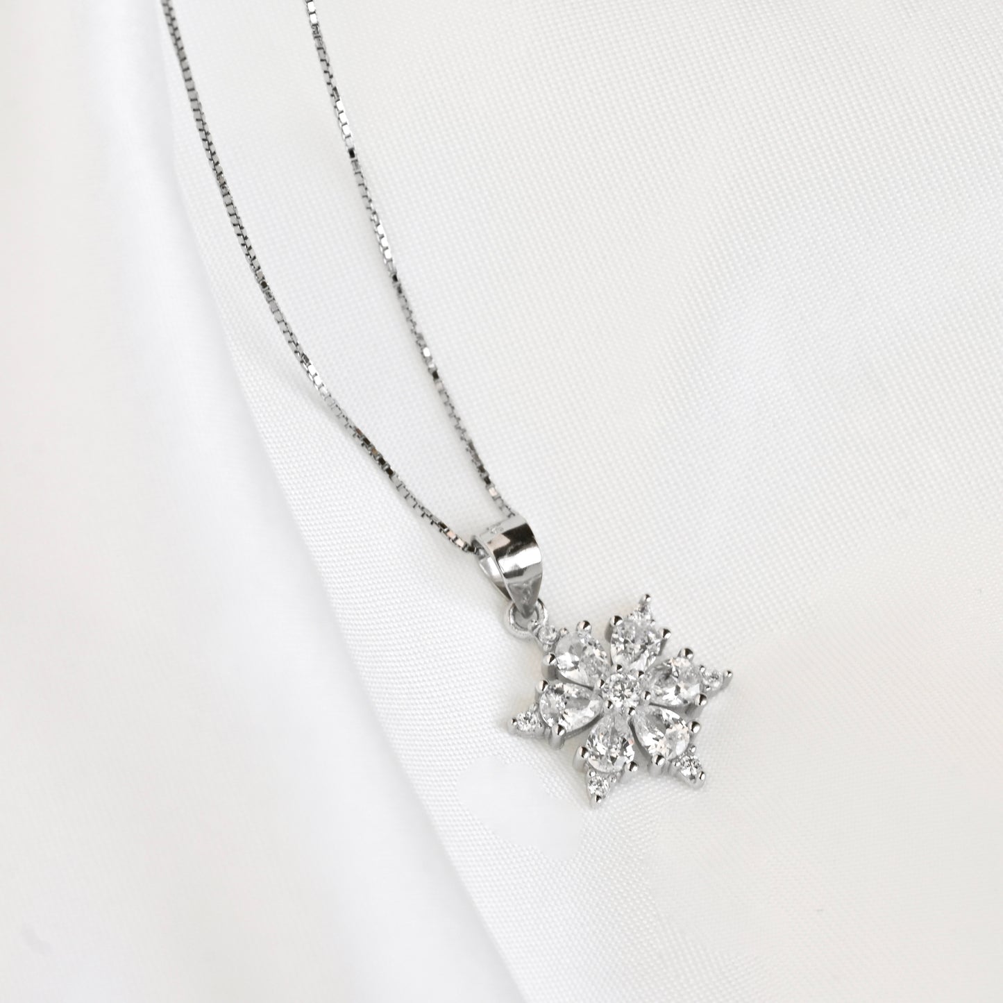 Silver Diamond necklace on a light gray background