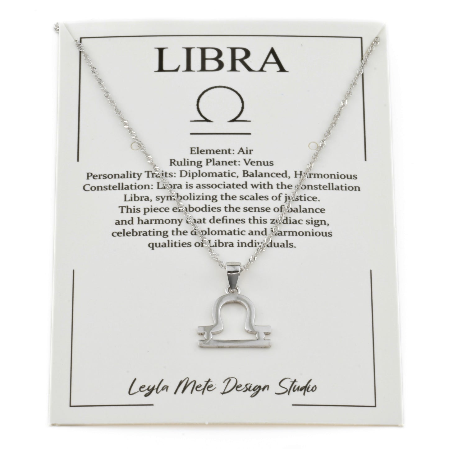 Silver Libra necklace on an informative card with zodiac text and branding