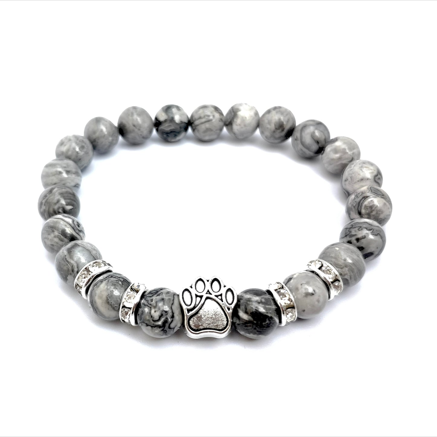 Gray beaded bracelet with a paw print charm under direct sunlight on a white background