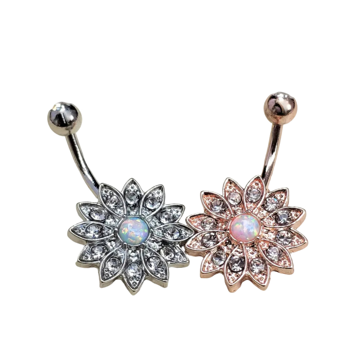 One gold and one silver sunflower belly button rings accented with crystals and an opal in the center on white surface