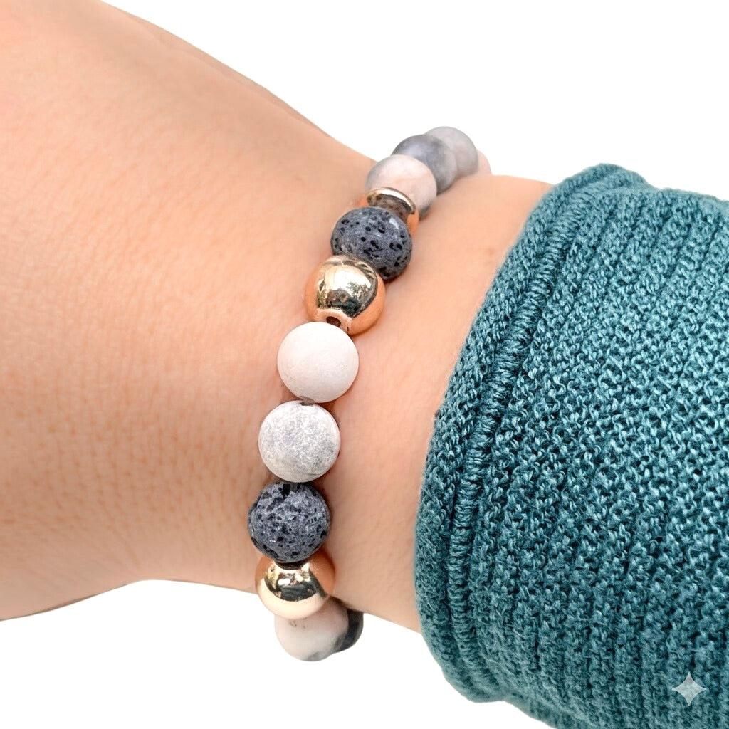 Anxiety bracelet with essential oil diffuser lava stone on a wrist against a white background