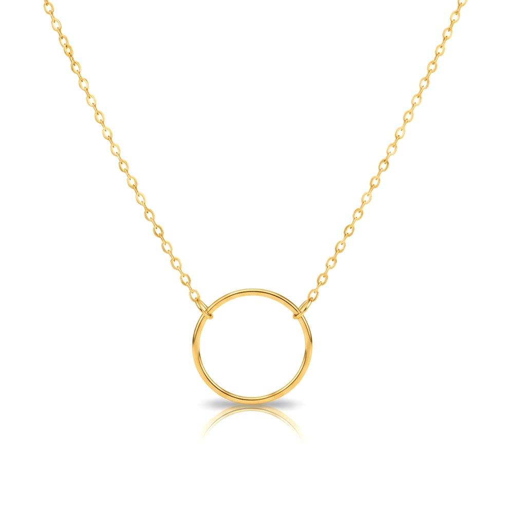 Gold necklace with a circular connector pendant on a white background
