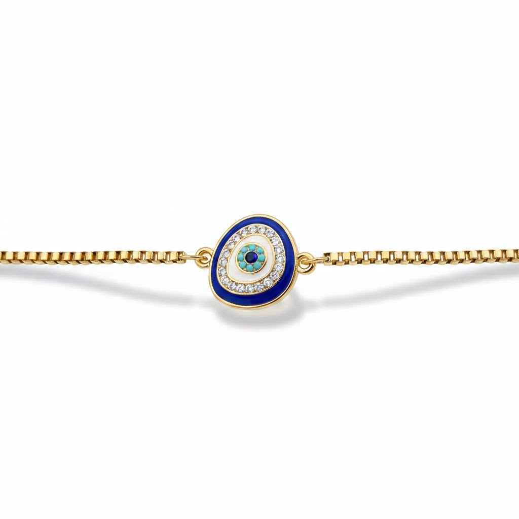 Gold box chain bracelet with a blue evil eye charm on a white background