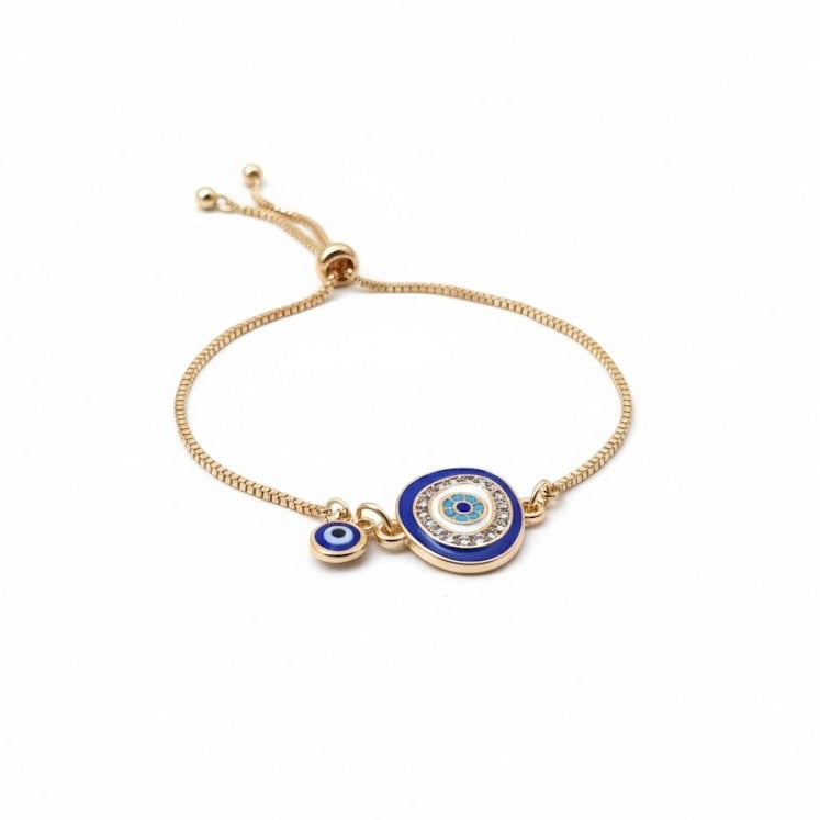 Gold bracelet with blue evil eye charm with turquoise beads and clear crystals on a white background