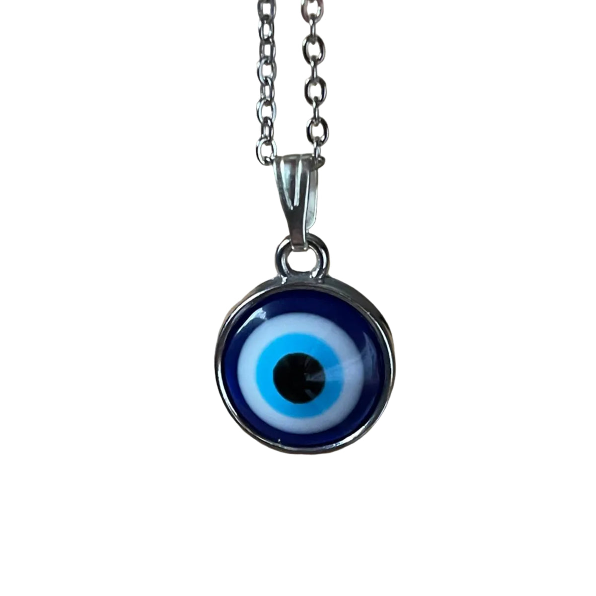 Evil eye pendant hanging from a silver chain on a white background