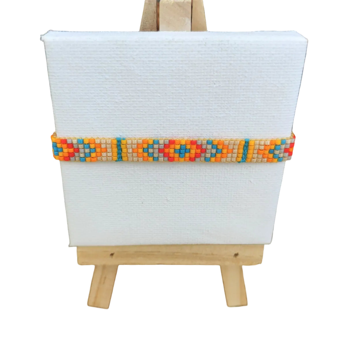 Small easel with a white board and colorful beaded bracelet