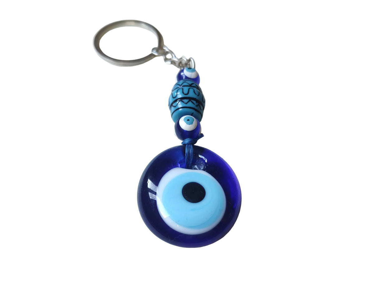 Blue evil eye keychain on a white backgorunf