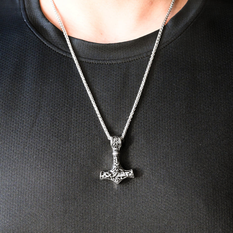 Write SEO friendly alt text for shopify image. Max 140 characters. Male Model in white shirt is wearing a silver eye of horus necklace